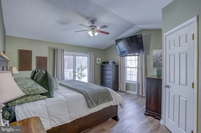 a bedroom with a large bed and a chandelier