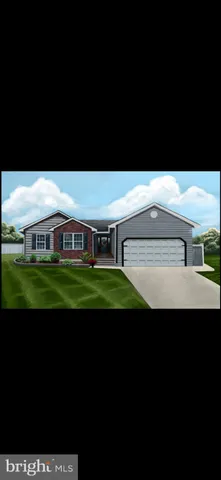 a green field with some trees in the background