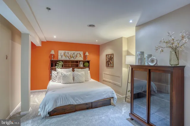 a bedroom with a large bed and a chandelier