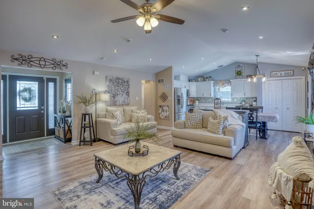a living room with furniture and kitchen view