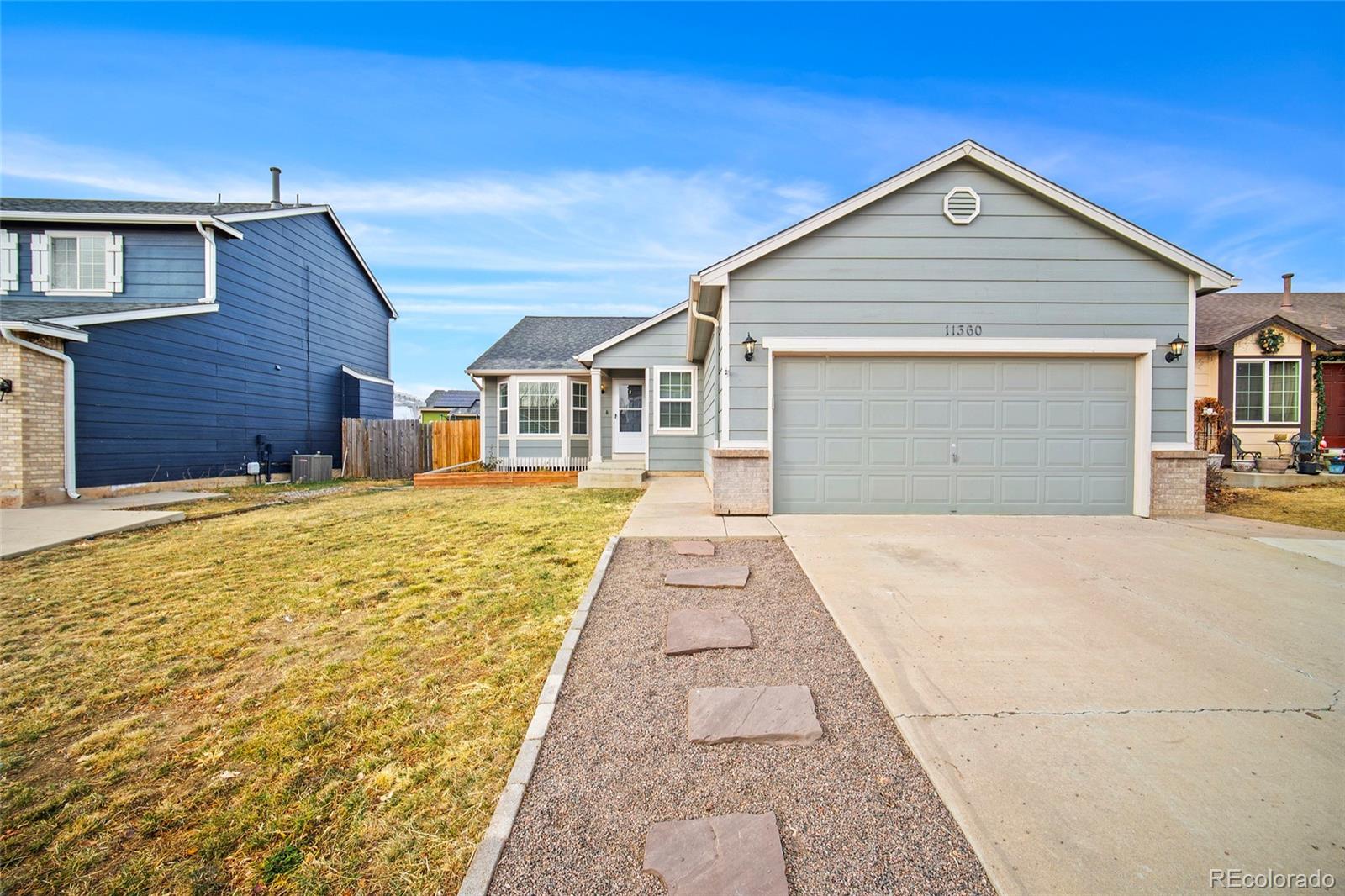11360 Berry Farm Road Fountain, CO 80817 - Photo 1 of 44 a front view of a house with a yard and garage