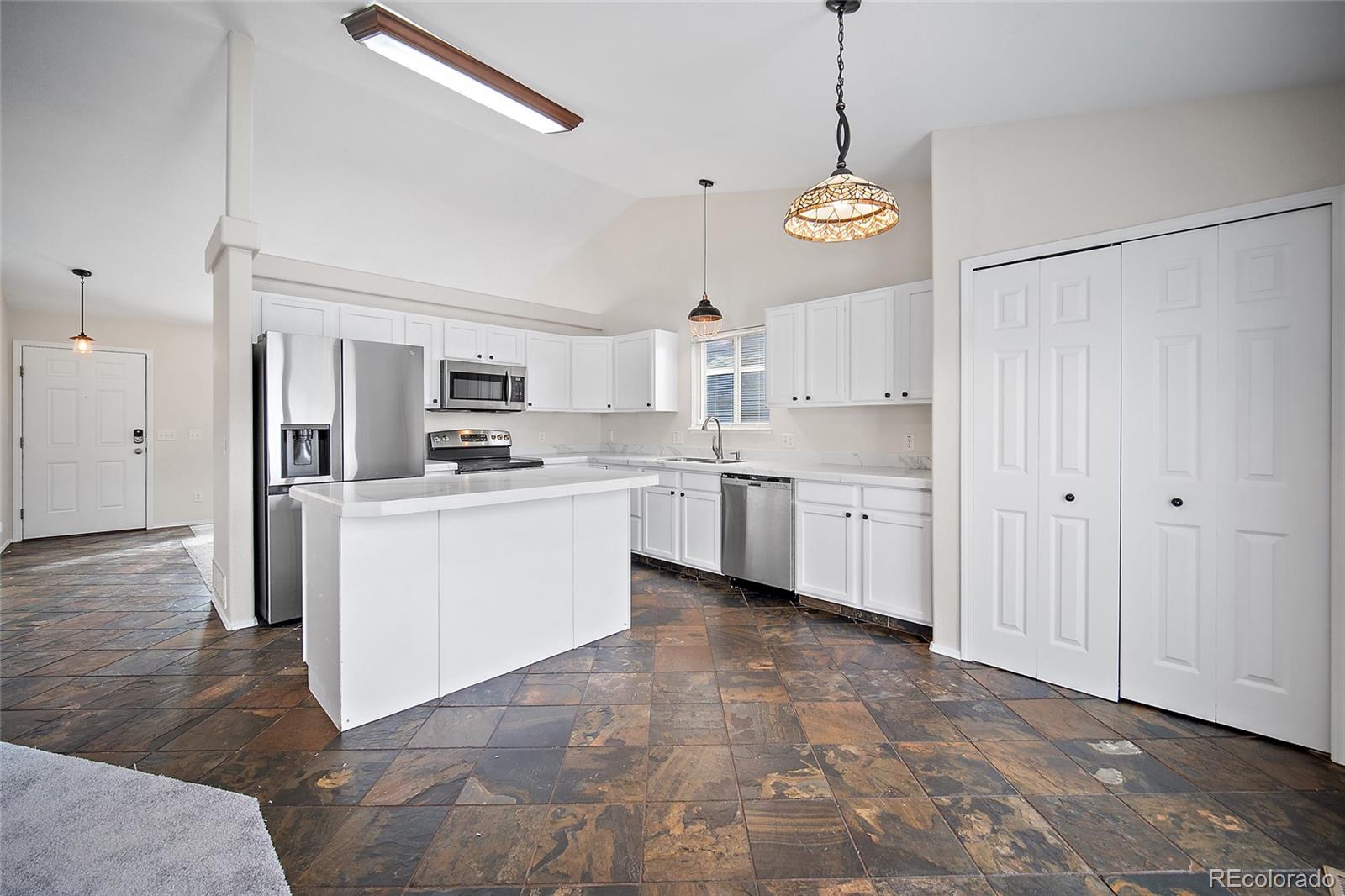 11360 Berry Farm Road Fountain, CO 80817 - Photo 12 of 44 a open kitchen with white cabinets and white appliances