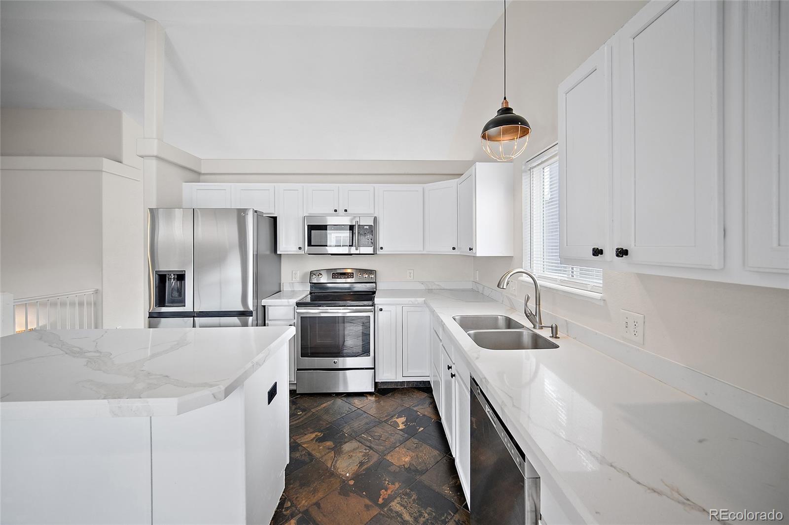 11360 Berry Farm Road Fountain, CO 80817 - Photo 13 of 44 a kitchen with stainless steel appliances granite countertop a sink stove and refrigerator