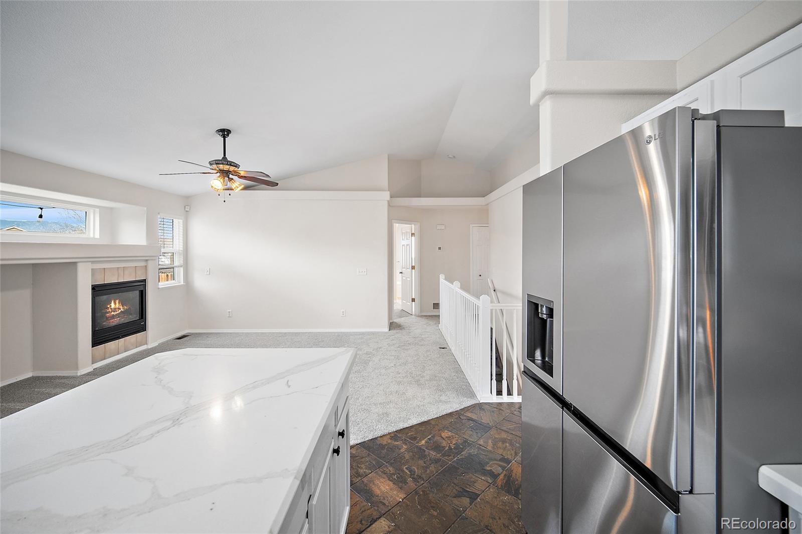 11360 Berry Farm Road Fountain, CO 80817 - Photo 14 of 44 a view of a kitchen with a sink and a fireplace