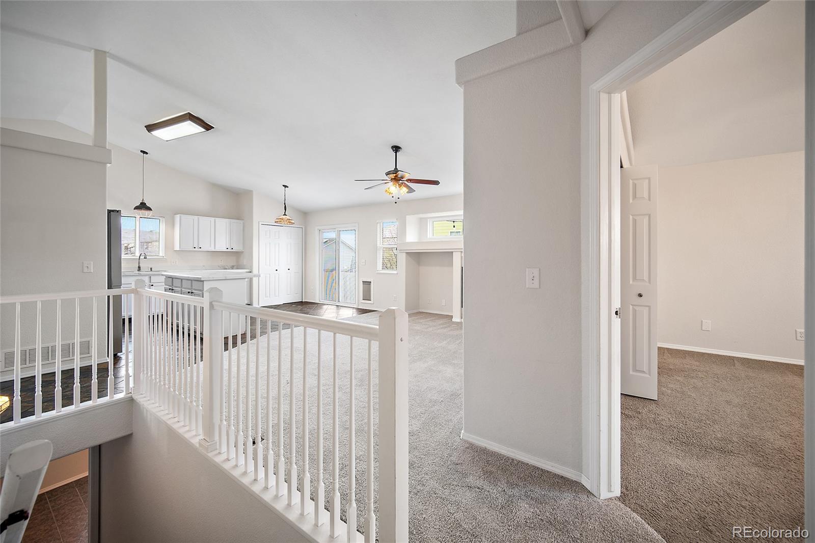 11360 Berry Farm Road Fountain, CO 80817 - Photo 19 of 44 a view of a hallway with a dining table & chairs