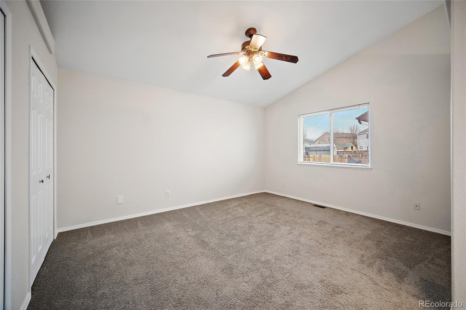 11360 Berry Farm Road Fountain, CO 80817 - Photo 20 of 44 an empty room with windows and fan