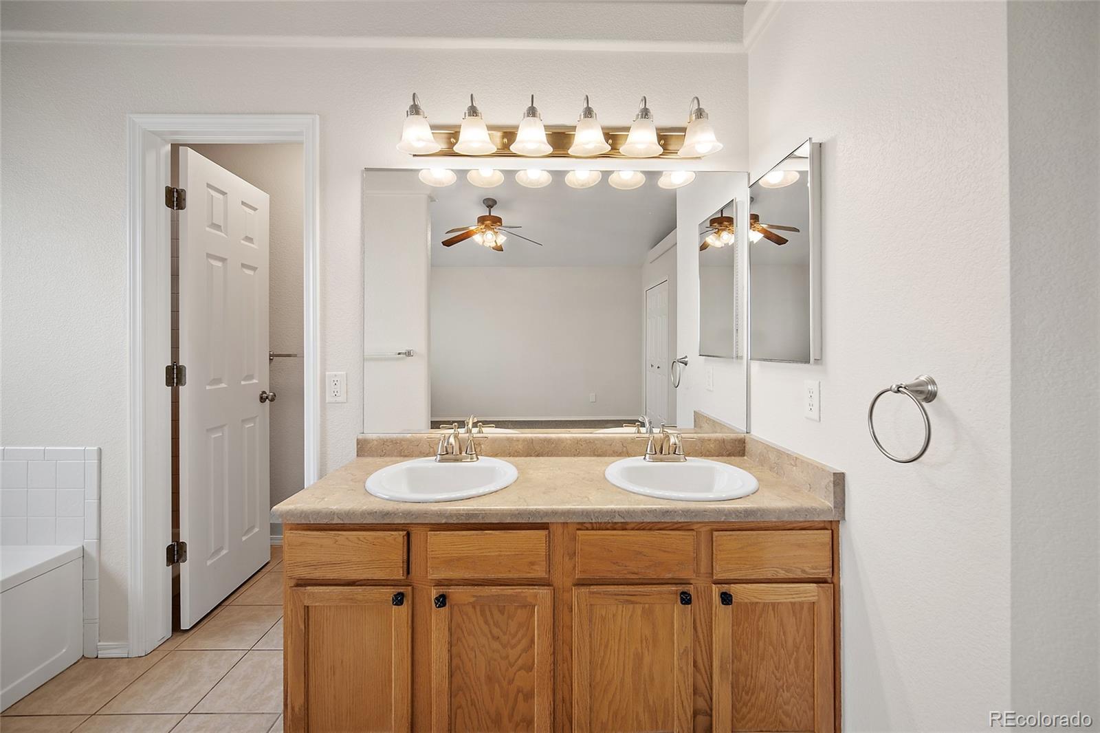 11360 Berry Farm Road Fountain, CO 80817 - Photo 24 of 44 a bathroom with a sink and mirror