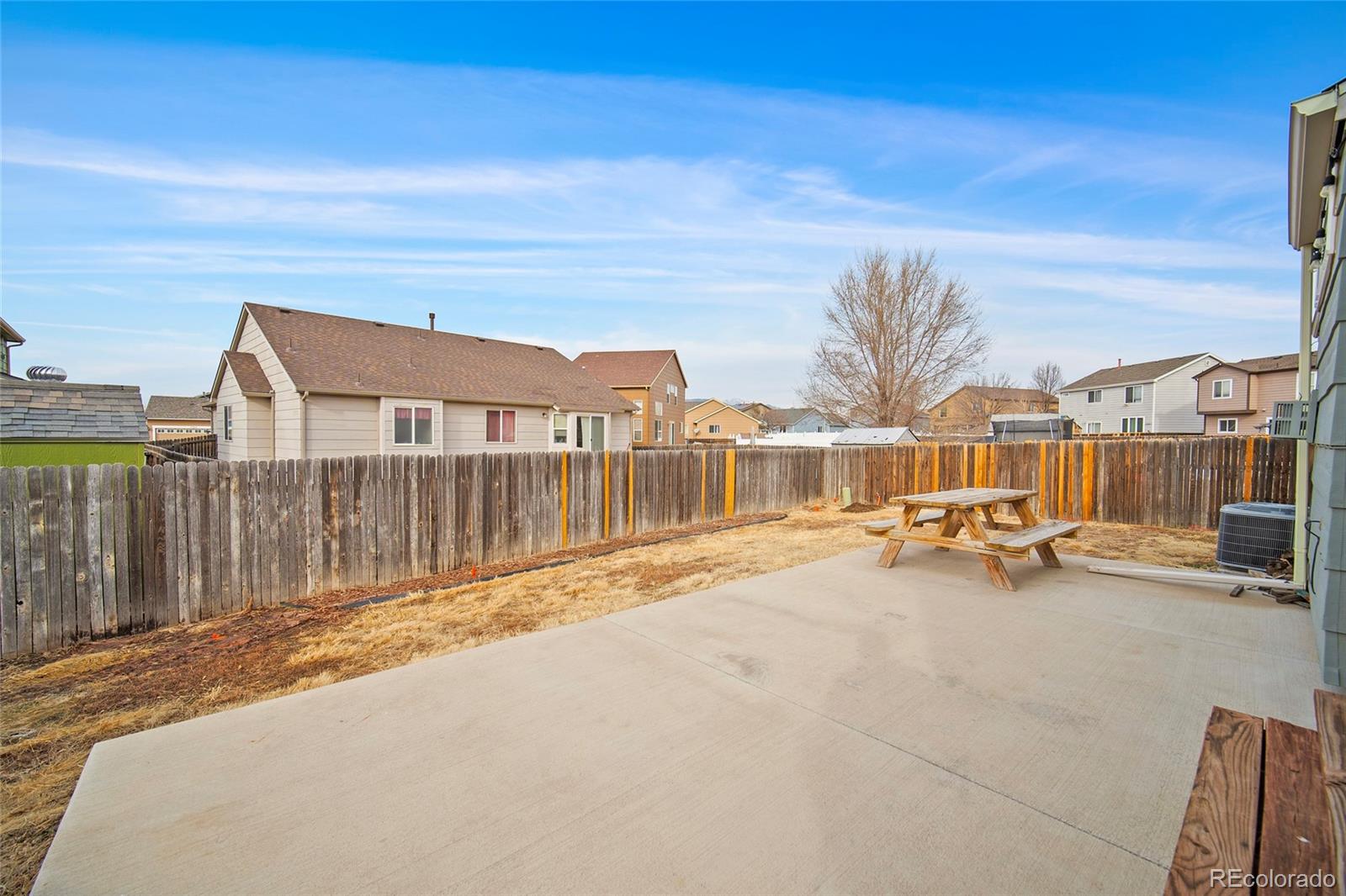 11360 Berry Farm Road Fountain, CO 80817 - Photo 36 of 44 a view of a building with floor to ceiling windows and wooden fence