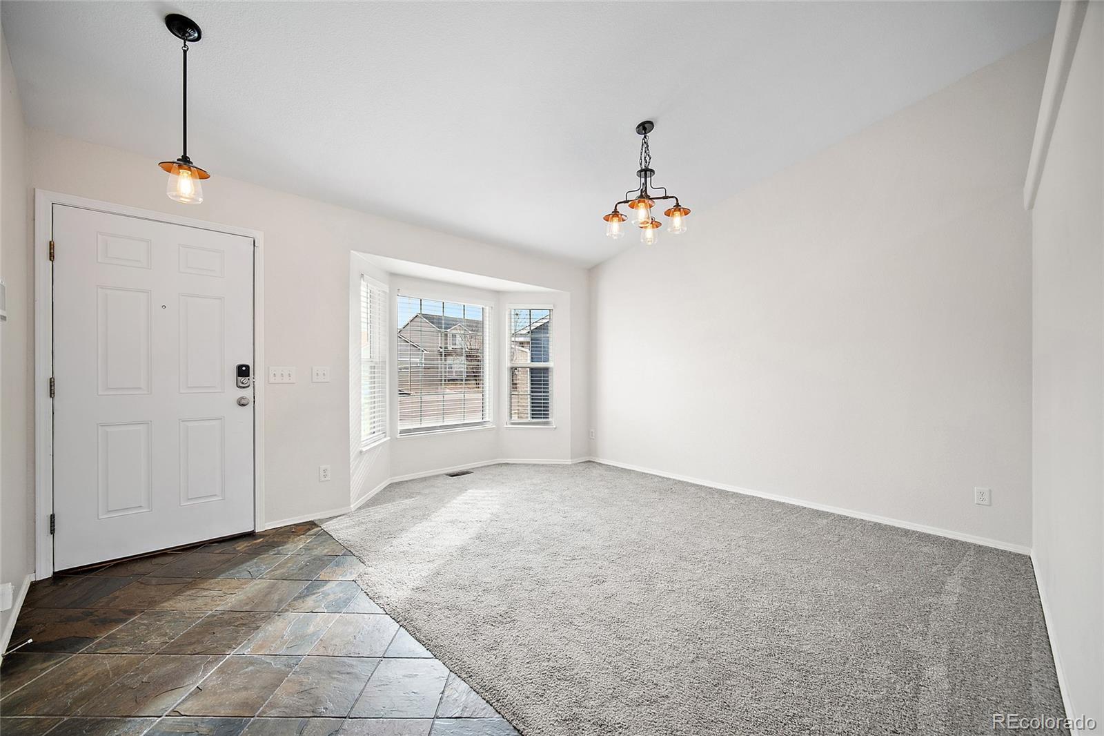 11360 Berry Farm Road Fountain, CO 80817 - Photo 5 of 44 a view of an empty room with a window
