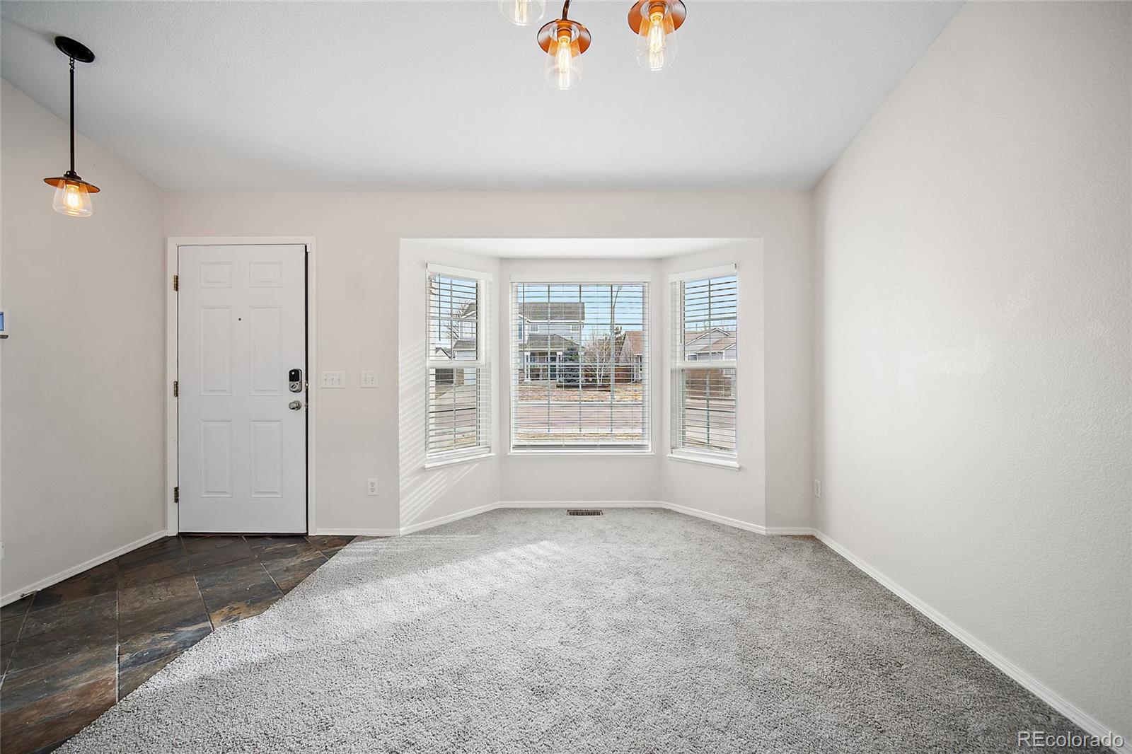 11360 Berry Farm Road Fountain, CO 80817 - Photo 6 of 44 a view of an empty room with a window