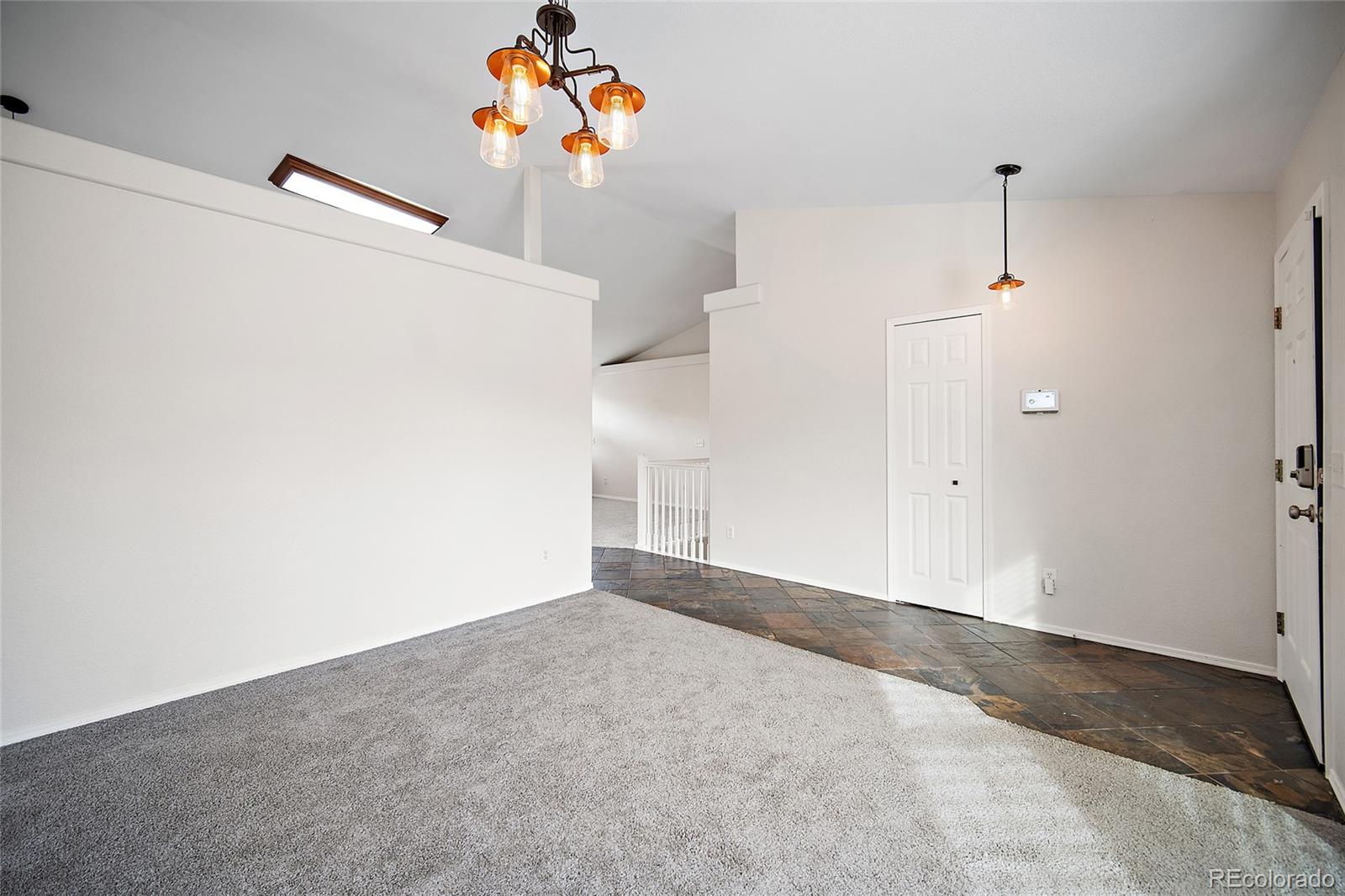11360 Berry Farm Road Fountain, CO 80817 - Photo 7 of 44 a view of a hallway with a refrigerator and cabinets