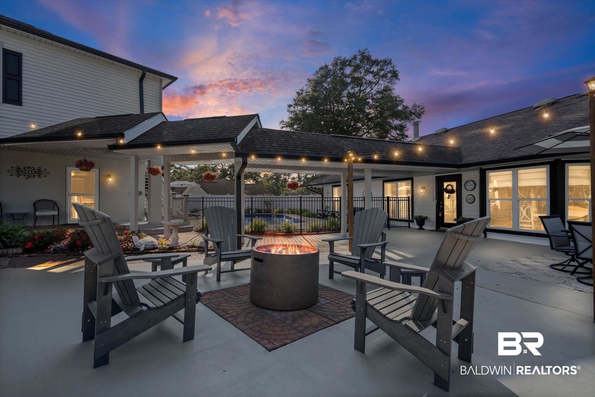 4567 Pine Avenue Saraland, AL 36571 - Photo 2 of 48 Patio terrace at dusk with a fire pit and a patio area