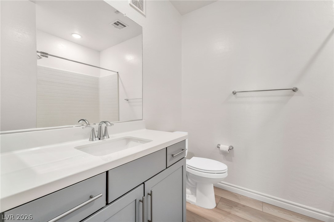 2555 Hampton Road, Unit 10108 Henderson, NV 89052 - Photo 17 of 23 An elegant vanity pairs with durable wood-look flooring in this modern bathroom layout.