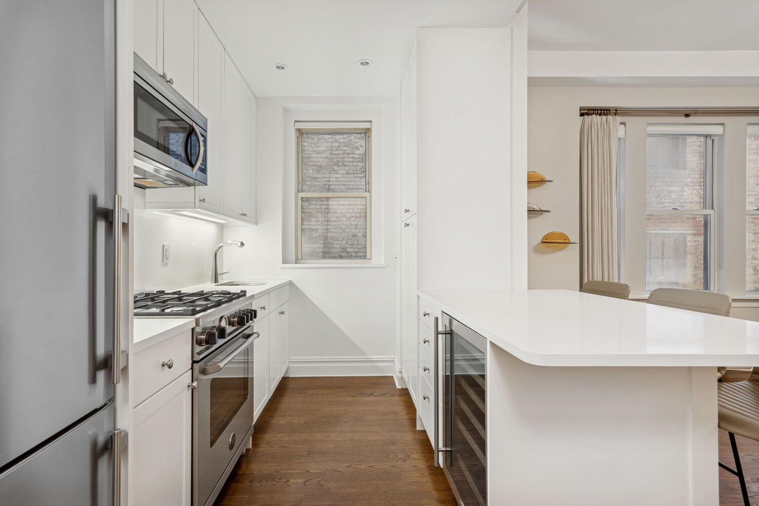 25 5th Avenue, Unit 3G Manhattan, NY 10003 - Photo 3 of 9 a kitchen with stainless steel appliances granite countertop a stove and a refrigerator