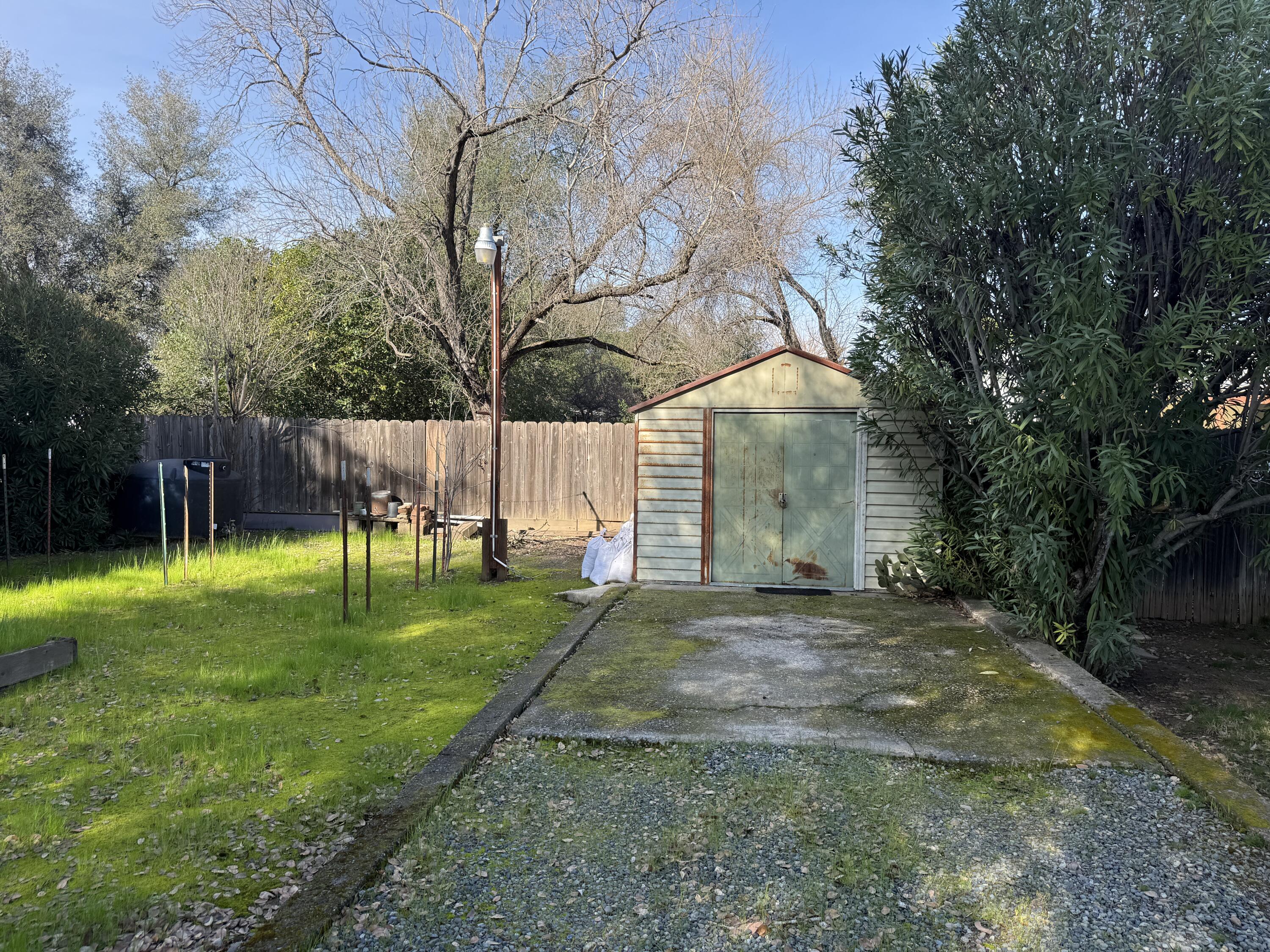 918 Parsons Drive Redding, CA 96002 - Photo 27 of 31 a view of a white house next to a yard with a big trees