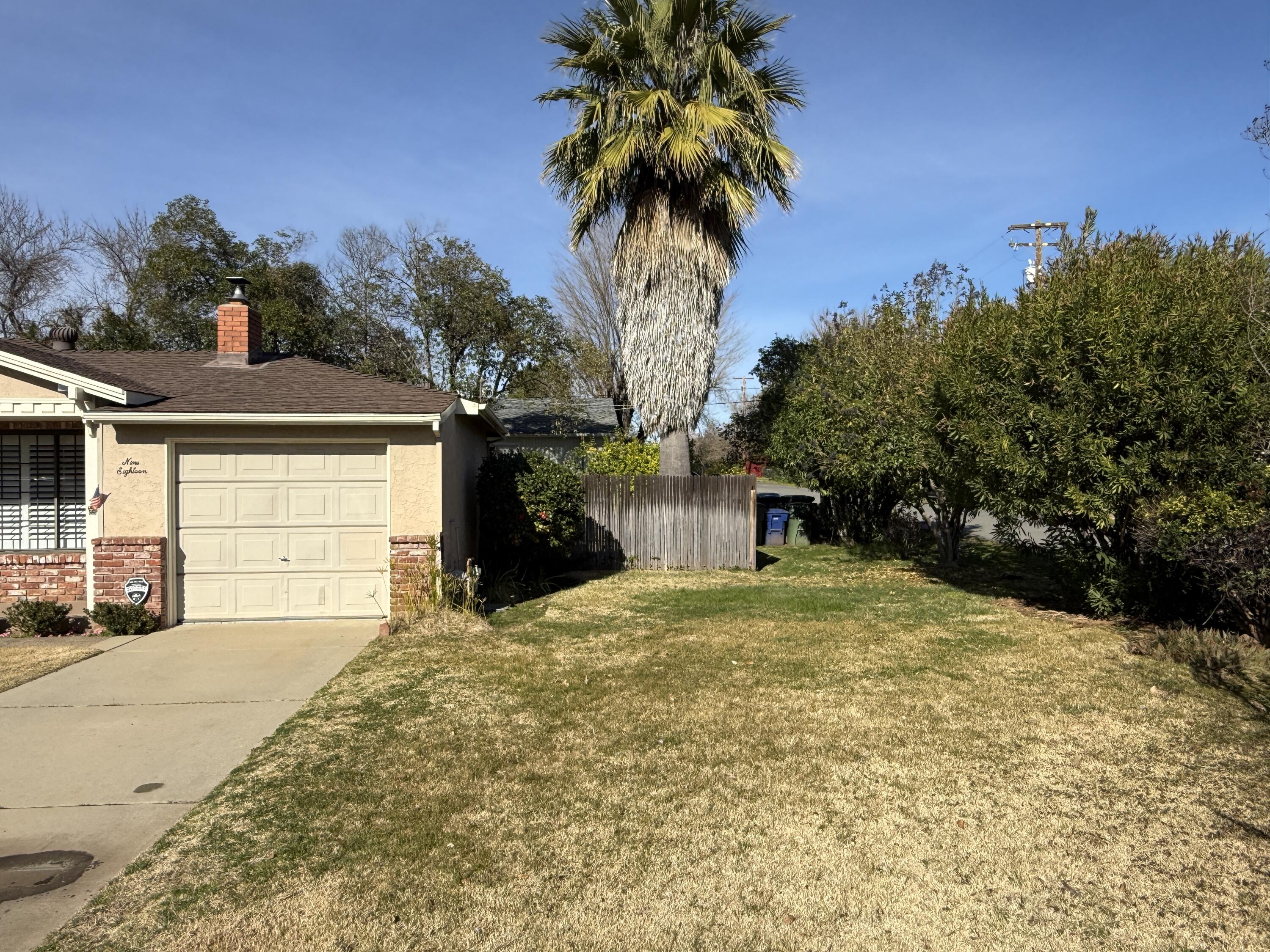 918 Parsons Drive Redding, CA 96002 - Photo 30 of 31 a front view of a house with a yard and garage