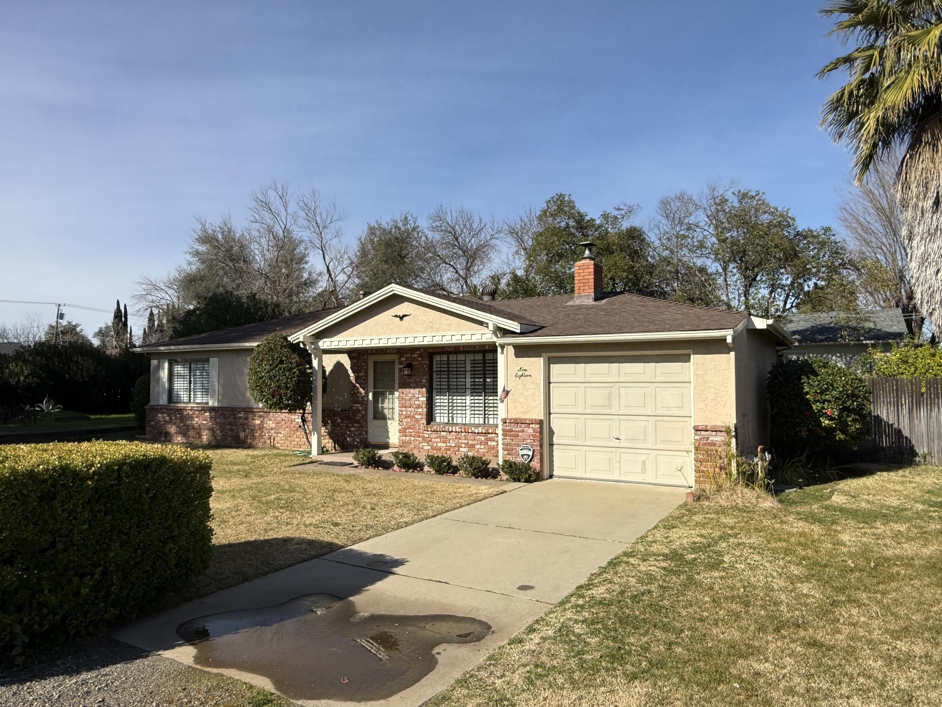 918 Parsons Drive Redding, CA 96002 - Photo 3 of 31 a front view of a house with a yard