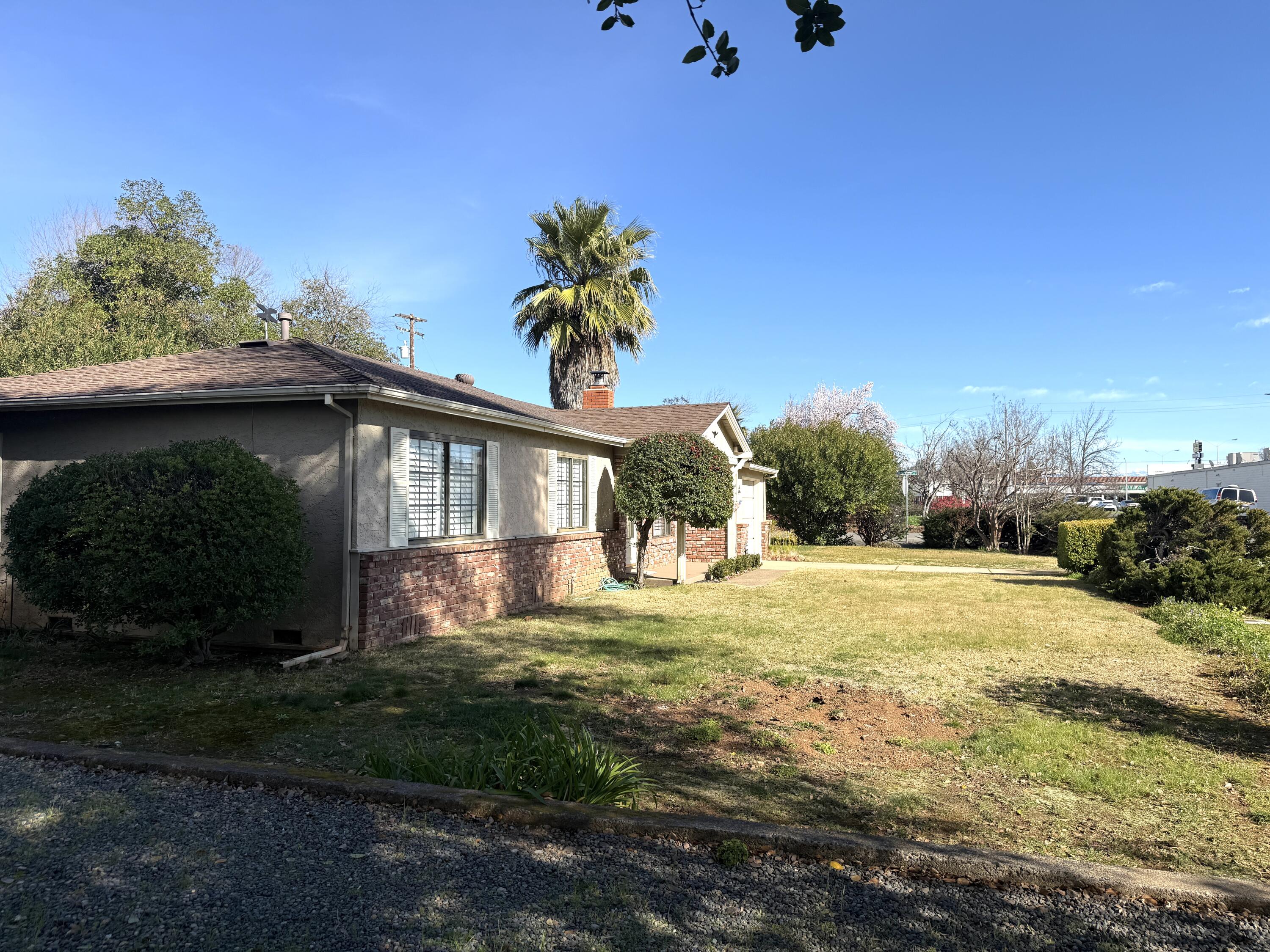 918 Parsons Drive Redding, CA 96002 - Photo 31 of 31 a yellow house with trees in front of it