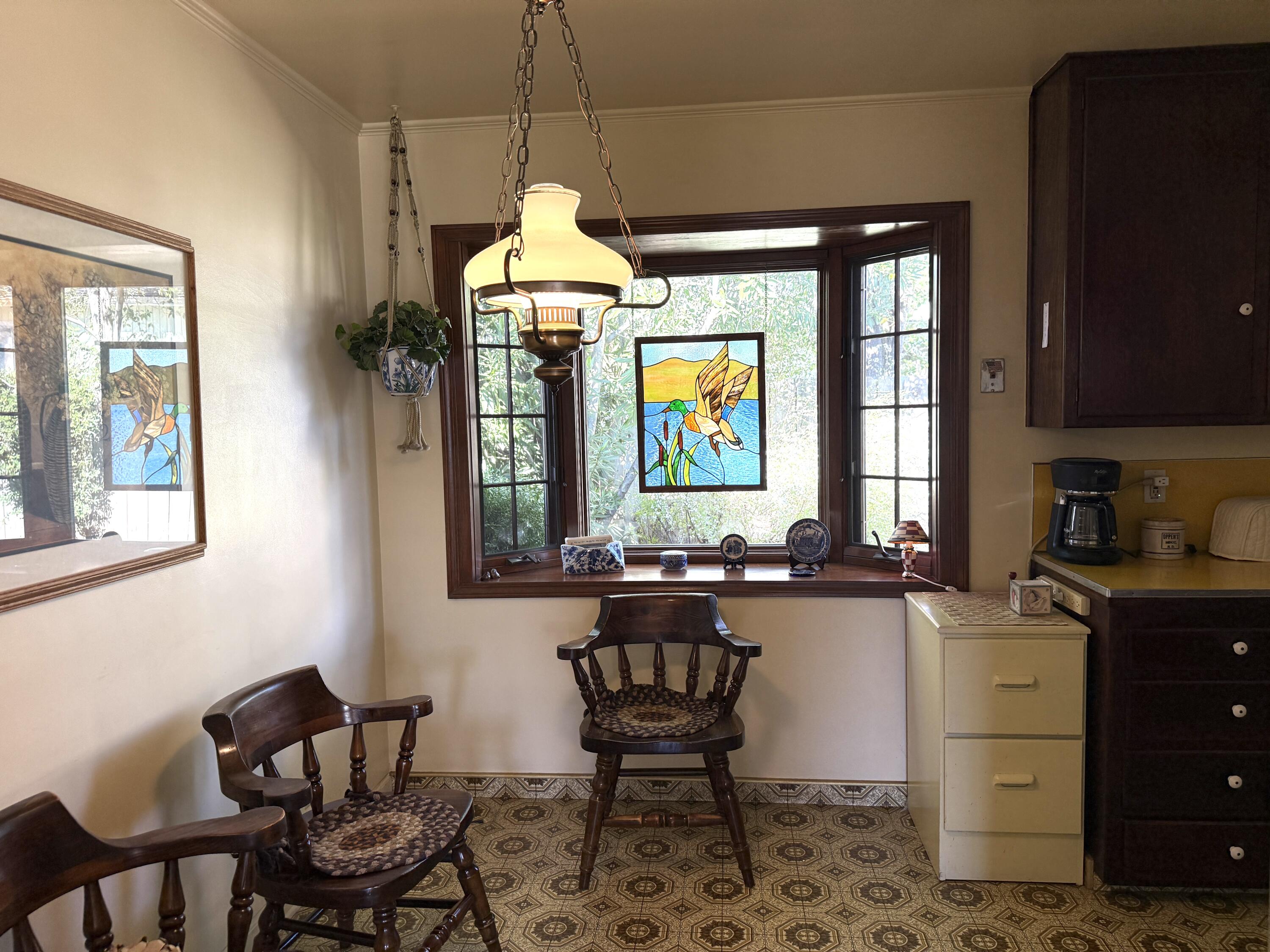 918 Parsons Drive Redding, CA 96002 - Photo 8 of 31 a kitchen with a refrigerator and table chairs