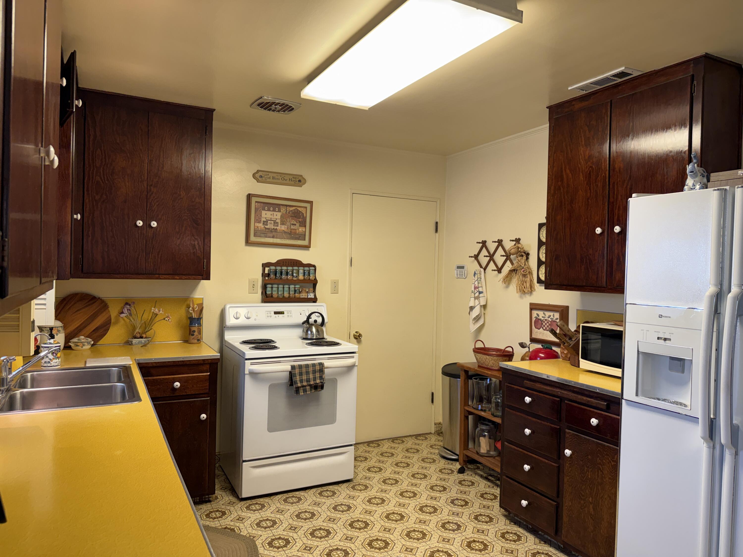 918 Parsons Drive Redding, CA 96002 - Photo 10 of 31 a kitchen with stainless steel appliances granite countertop a stove and a refrigerator