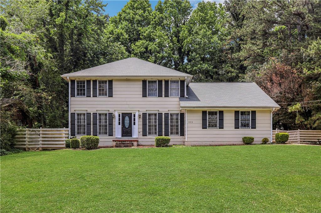 555 Rowland Road Stone Mountain, GA 30083 - Photo 1 of 1 a front view of a house with a garden