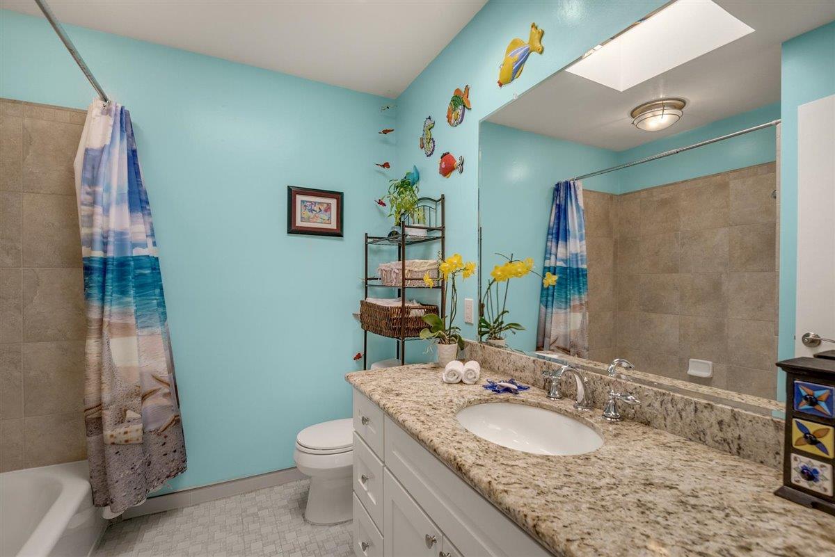 16300 Old Ranch Road Los Gatos, CA 95033 - Photo 15 of 26 a bathroom with a granite countertop toilet a sink and a mirror