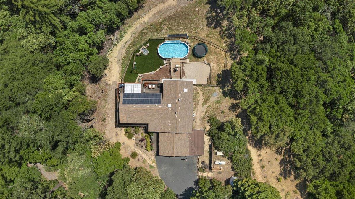 16300 Old Ranch Road Los Gatos, CA 95033 - Photo 22 of 26 an aerial view of a house with a yard and trees all around