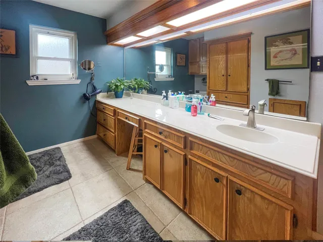 a spacious bathroom with a sink and a mirror