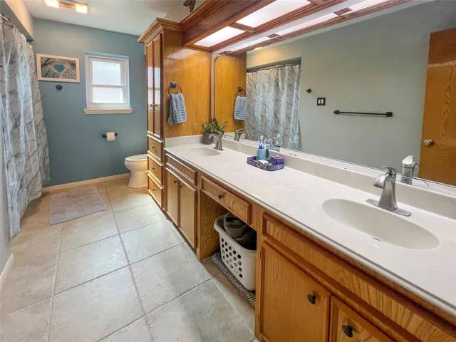 a spacious bathroom with a double vanity sink and a mirror