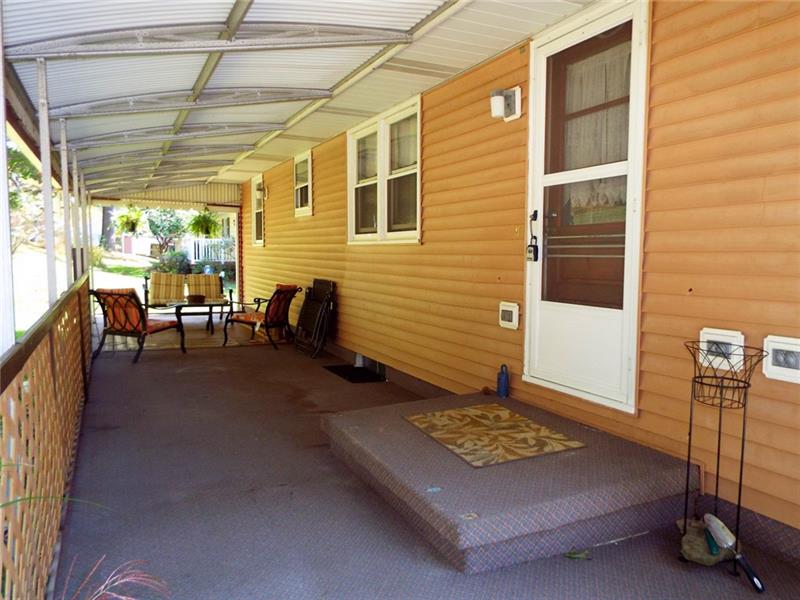 447 Harvey Road Foxburg, PA 16036 - Photo 18 of 23 Enjoy the breeze in this covered patio which is the full length of the home and offers covered entrance into the kitchen.