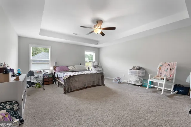 a spacious bedroom with a bed and a couch