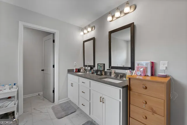 a bathroom with a double vanity sink and a mirror