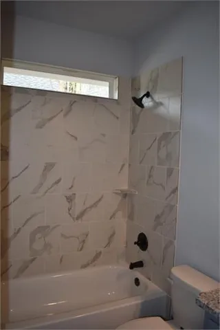 a bathroom with a shower and a toilet