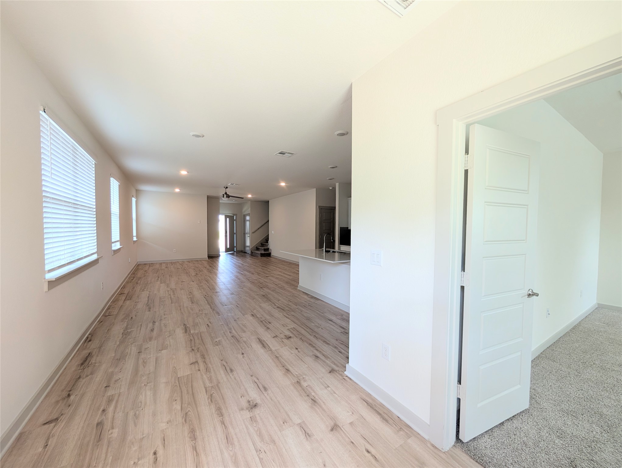 261 Century Plant Road Leander, TX 78641 - Photo 24 of 25 An open floorplan seamlessly connects the well-lit living area, showcasing attractive wood flooring.