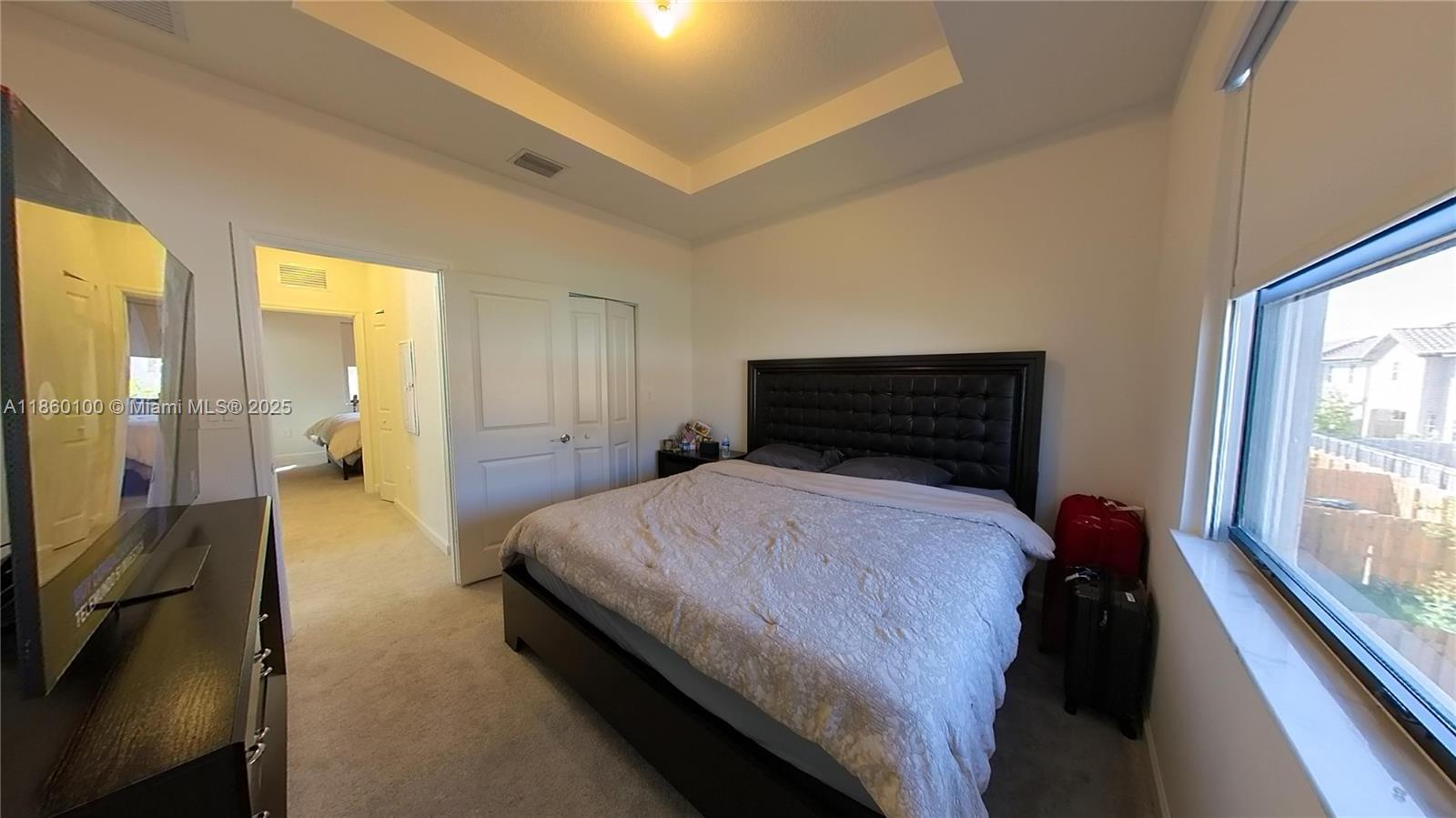 11721 Southwest 245 Terrace Homestead, FL 33032 - Photo 11 of 13 a bedroom with a bed and a large window