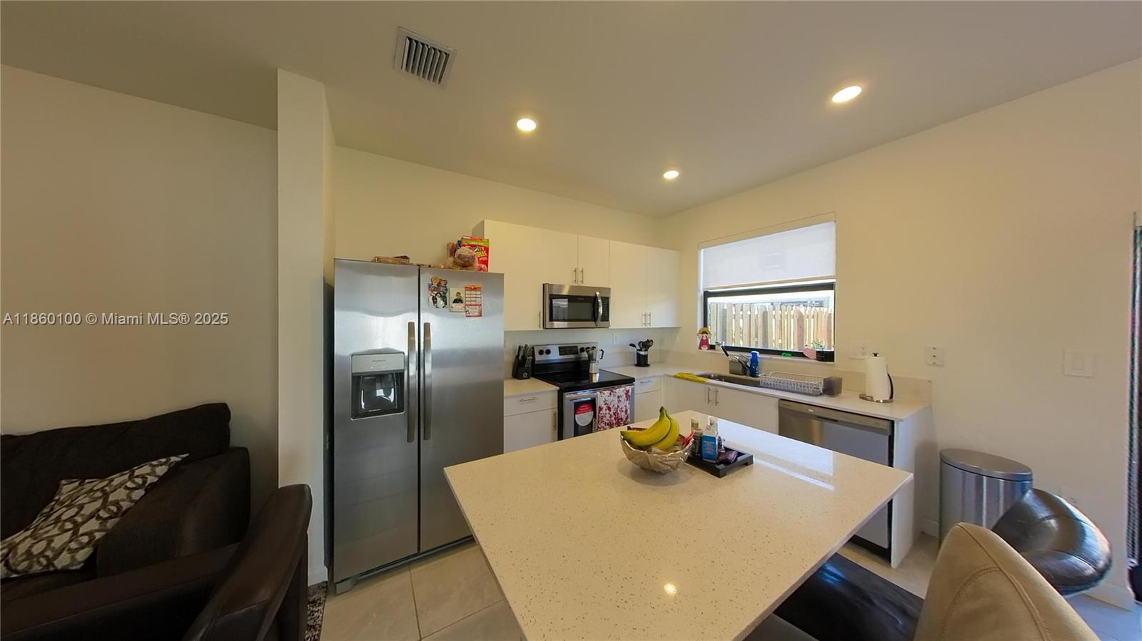 11721 Southwest 245 Terrace Homestead, FL 33032 - Photo 7 of 13 a kitchen with a refrigerator and a stove top oven