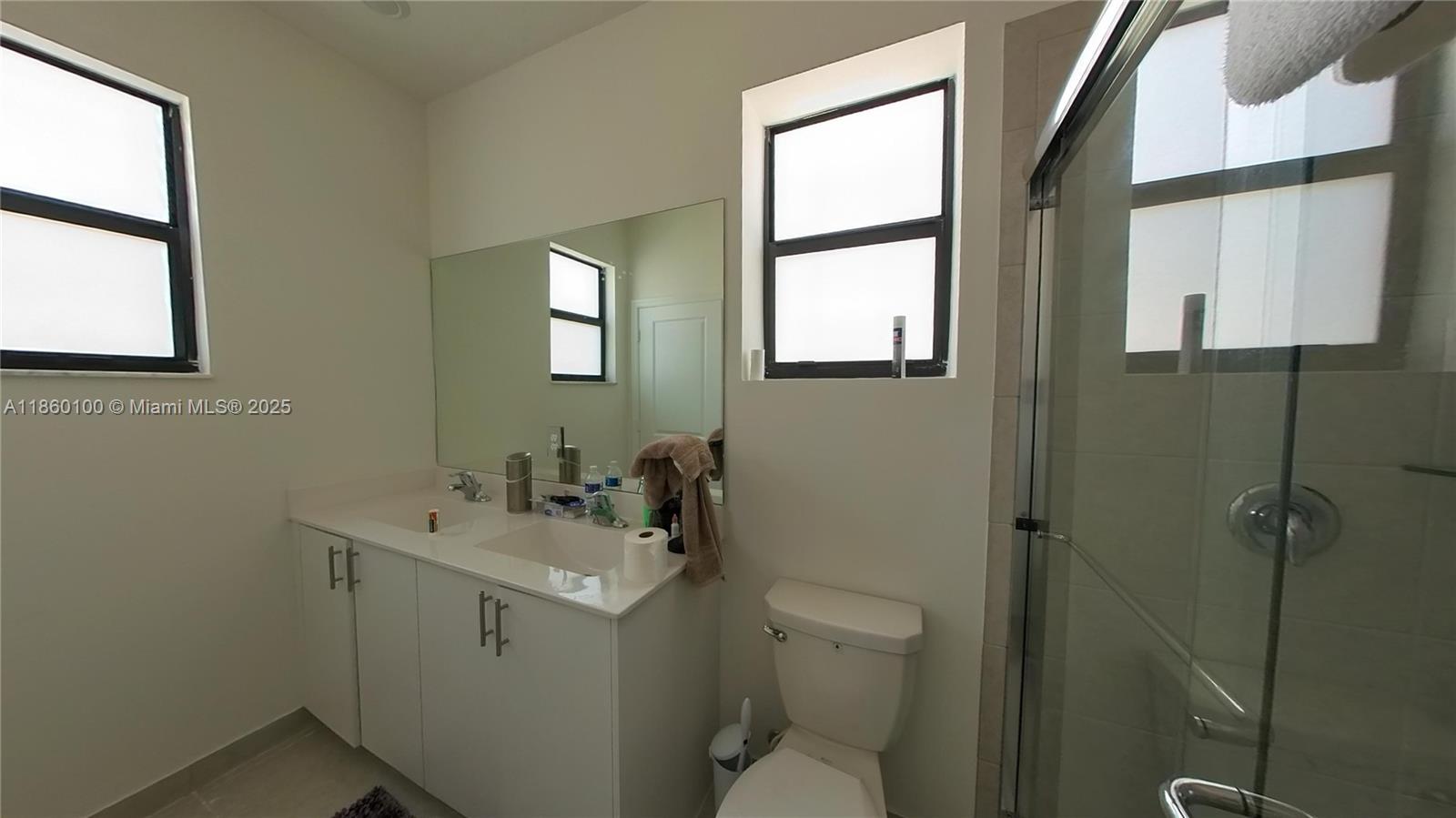 11721 Southwest 245 Terrace Homestead, FL 33032 - Photo 9 of 13 a bathroom with a toilet sink and mirror