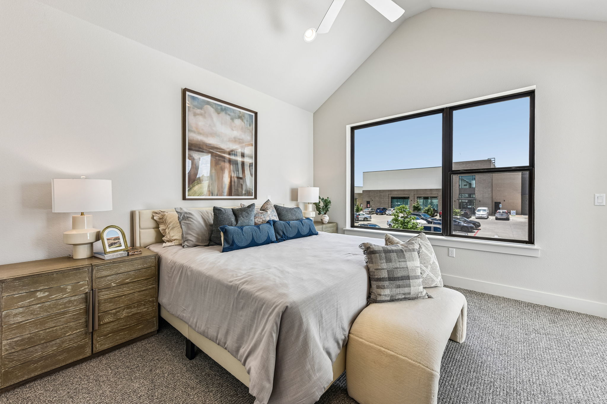 9033 Cattle Baron Path Austin, TX 78747 - Photo 28 of 40 Natural light floods this primary bedroom featuring a vaulted ceiling and textured carpet, offering comfortable living.