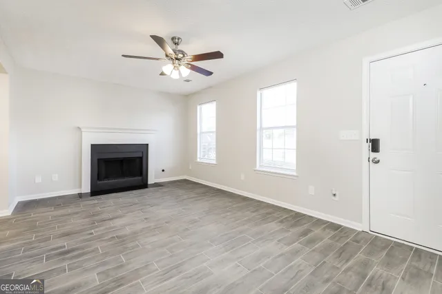 a view of a livingroom with a fireplace and window