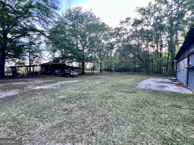 3195 Henderson Grove Road Sandersville, GA 31082 - Photo 49 of 50 a view of a yard with a house and a tree