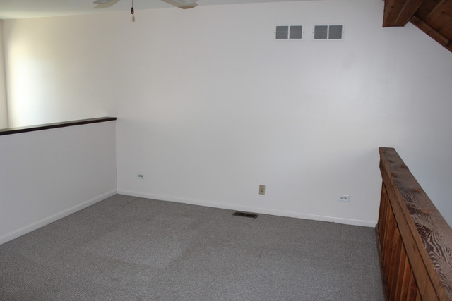 704 Wakefield Road Gurnee, IL 60031 - Photo 8 of 20 an empty room with a kitchen