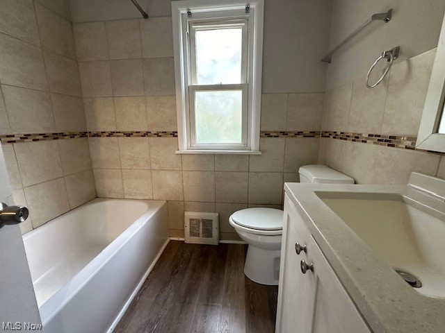 4230 Bluestone Road South Euclid, OH 44121 - Photo 16 of 35 Bathroom featuring tile walls, hardwood flooring, a wealth of natural light, and toilet