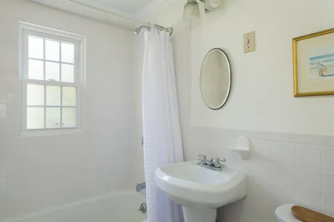 a bathroom with a sink a mirror and a shower