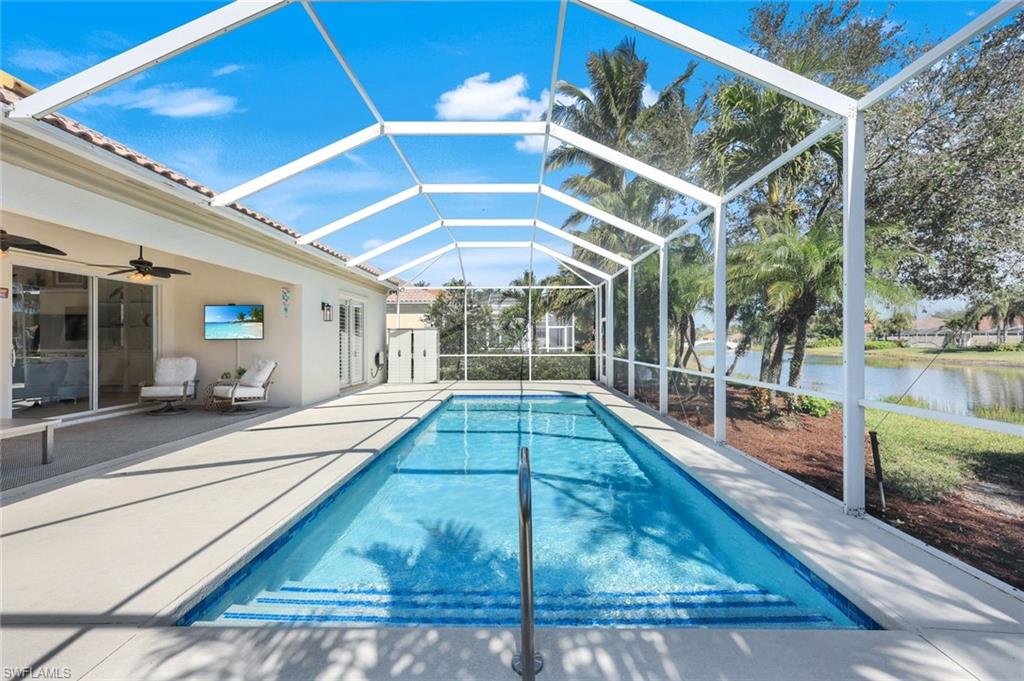 3108 Dominica Way Naples, FL 34119 - Photo 22 of 39 Screened-in swimming saltwater pool with a s integrated steps, and surrounding decking. Overlooking lake.