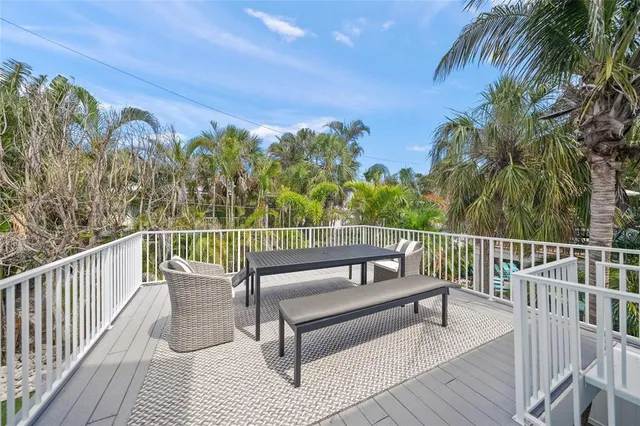 a view of a roof deck with wooden floor and fence