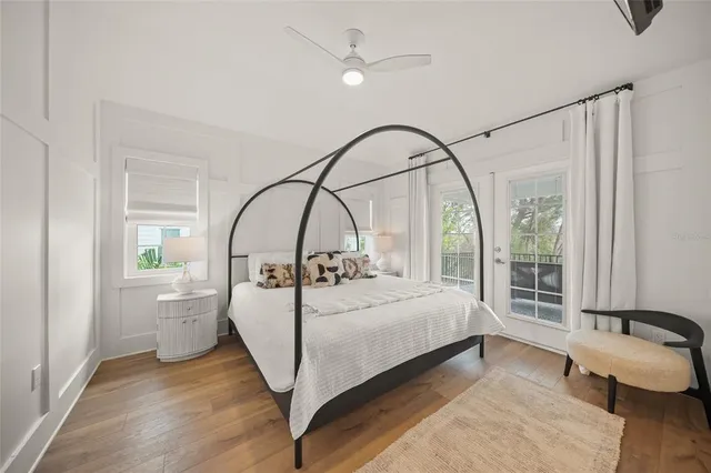 a bedroom with a bed and a large window with outer view