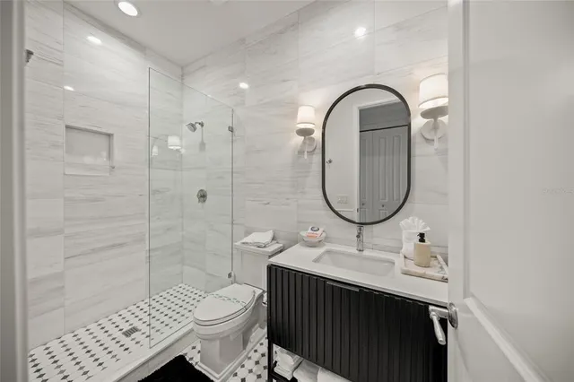 a bathroom with a sink a toilet and shower