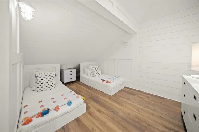 a bedroom with a bed and a white cabinet