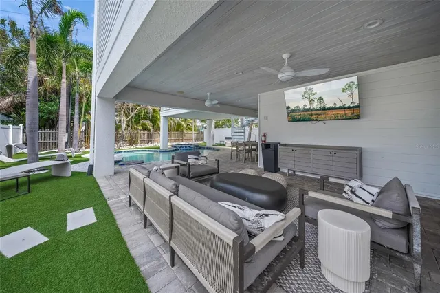 a living room with patio furniture and a garden