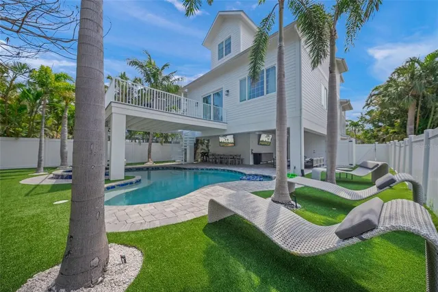 a view of a house with backyard sitting area and garden
